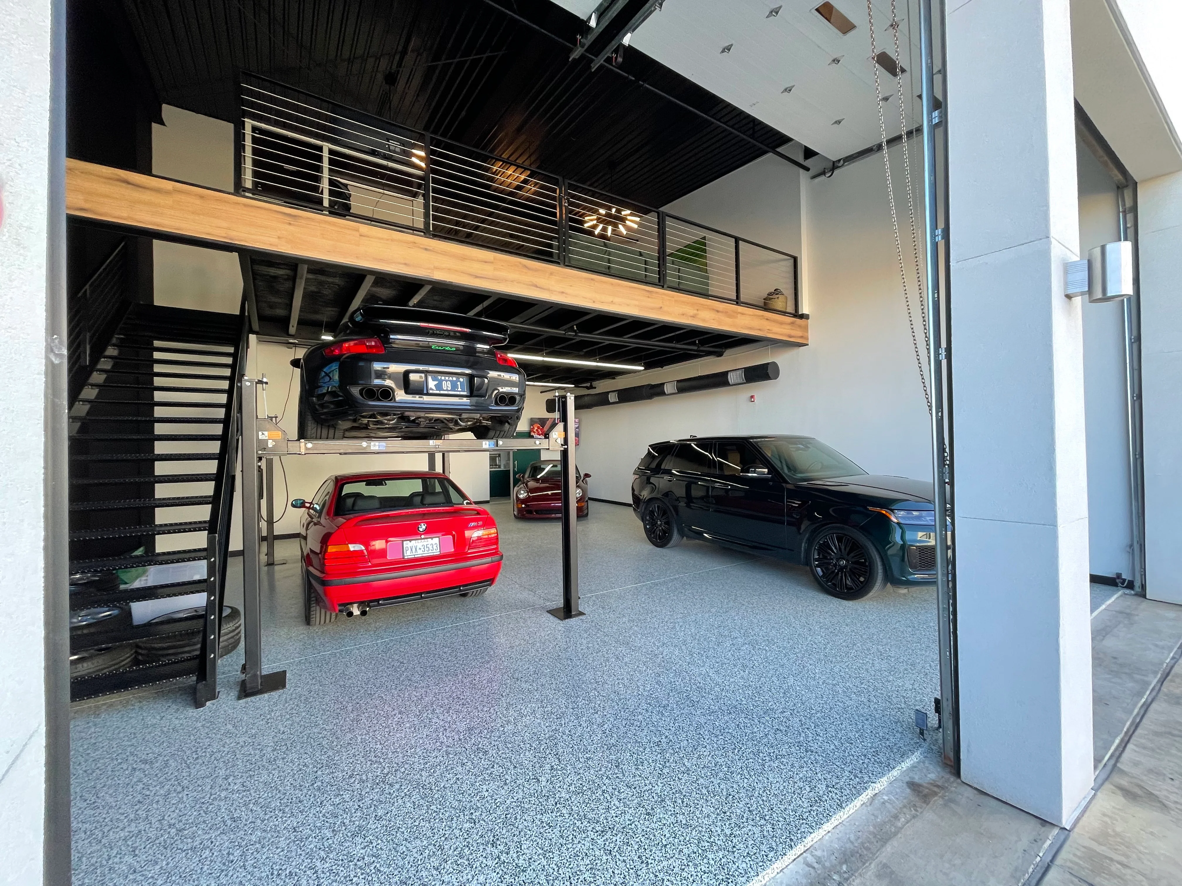 Open lift garage with multiple cars